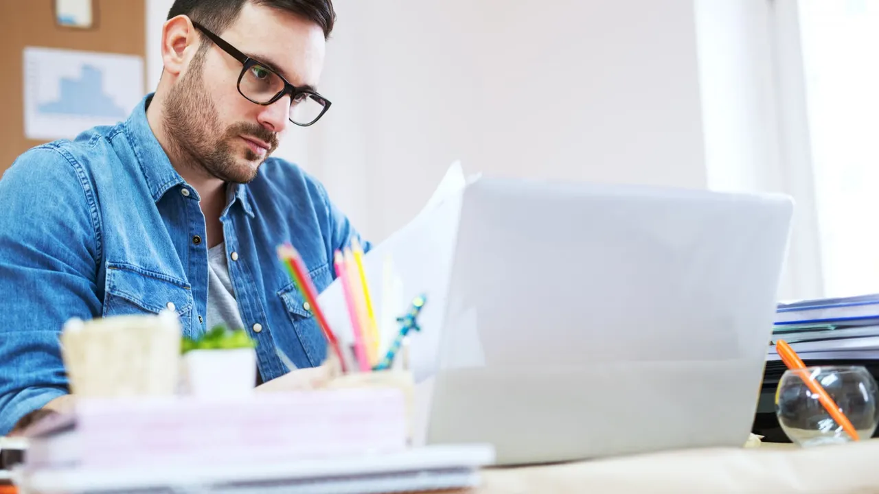 A man looking at a laptop screen.