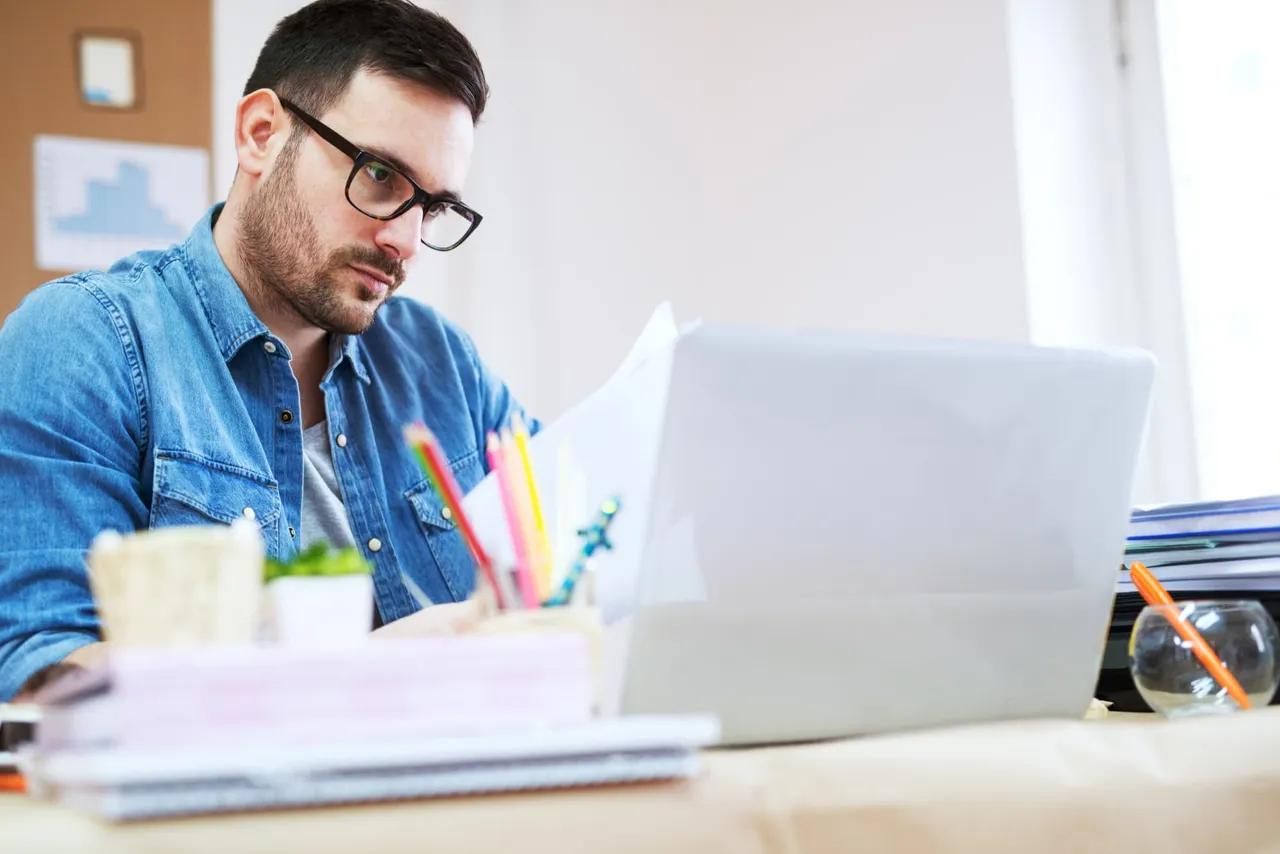 A man looking at a laptop screen.