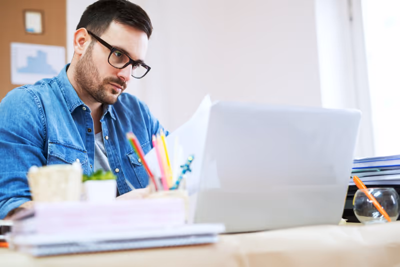 A man looking at a laptop screen.