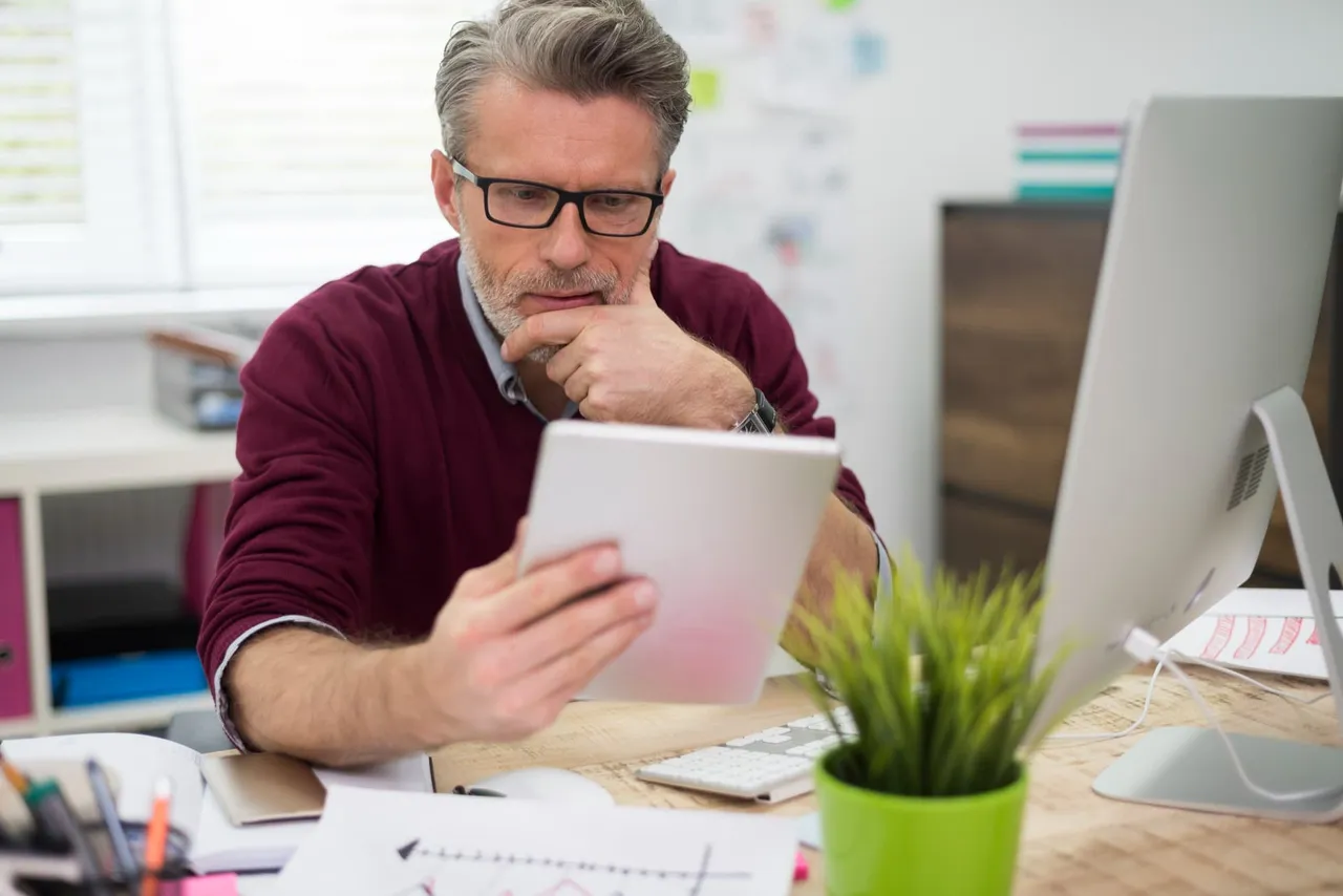 A service business owner reviewing their website on a laptop at a desk