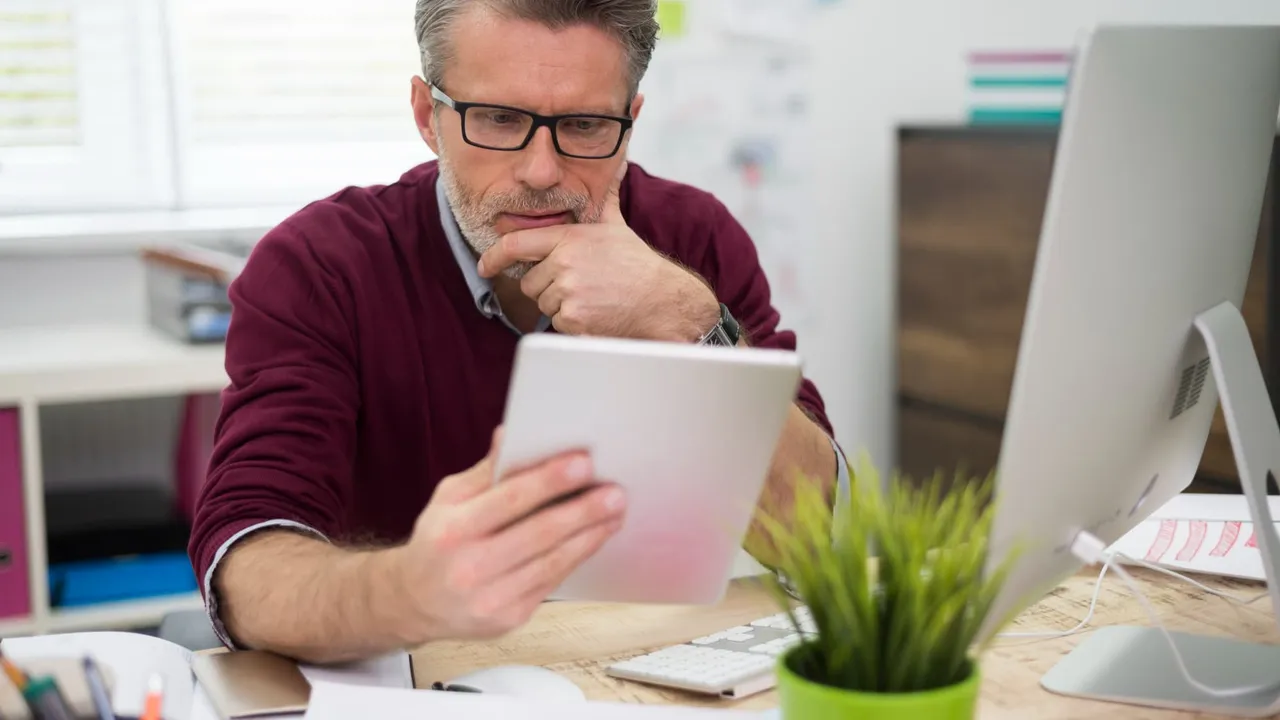 A service business owner reviewing their website on a laptop at a desk