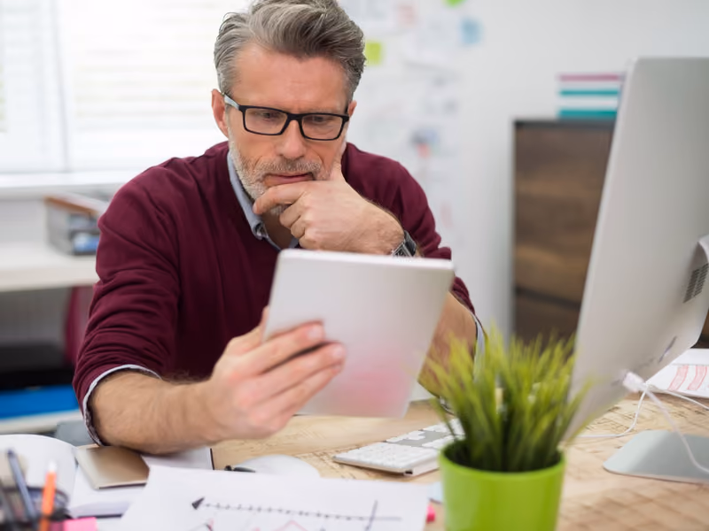 A service business owner reviewing their website on a laptop at a desk