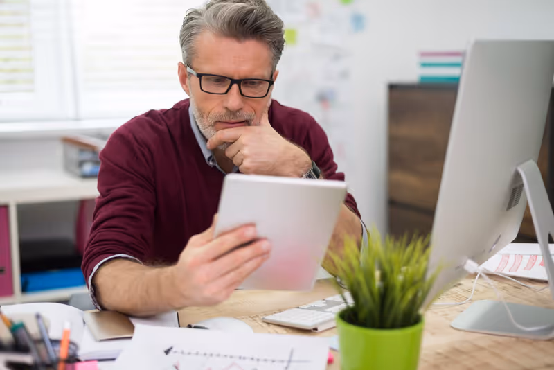 A service business owner reviewing their website on a laptop at a desk