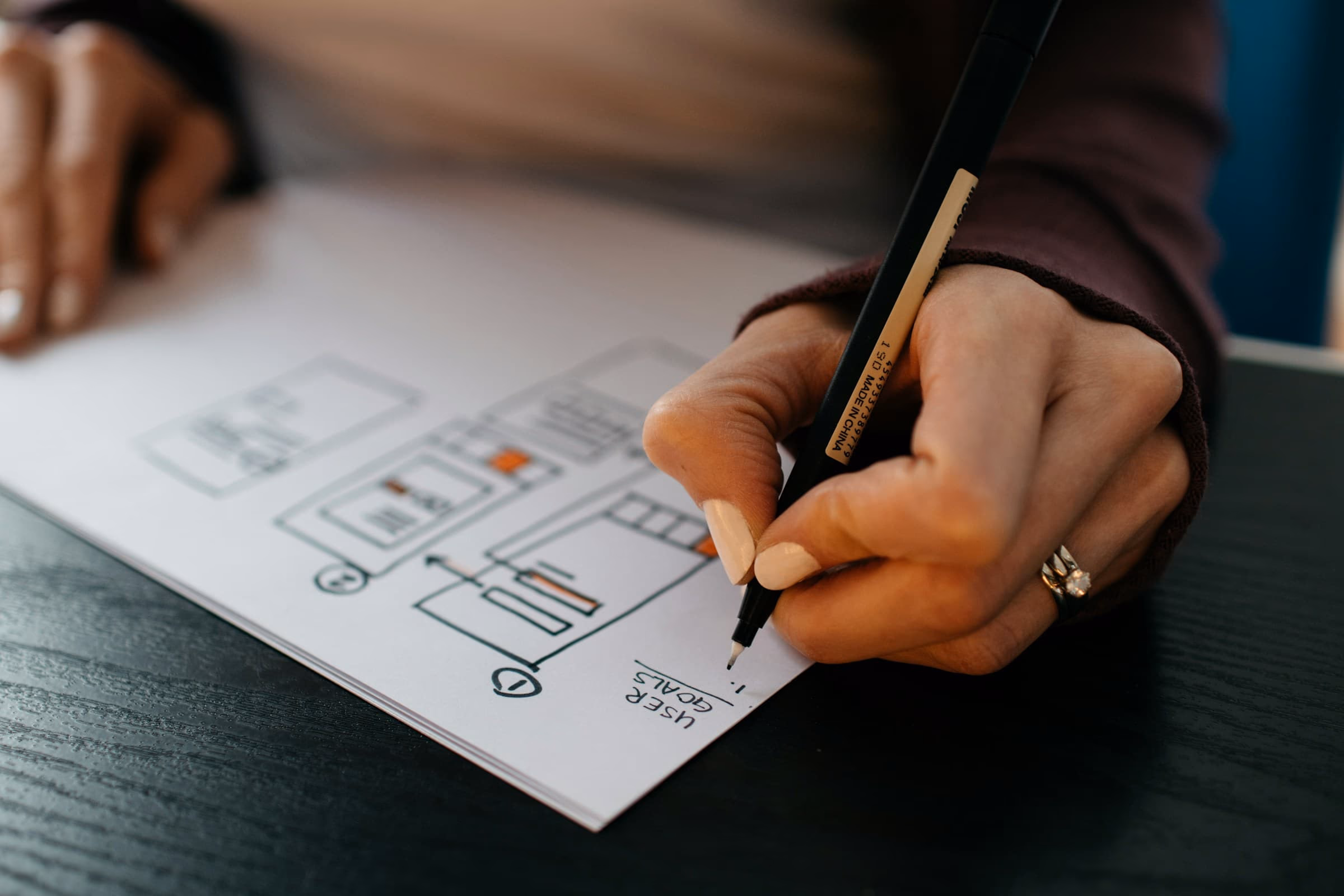 Person planning website improvements during a service business redesign audit.